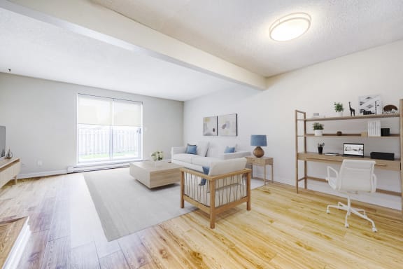 the living room of an apartment with a couch and a table