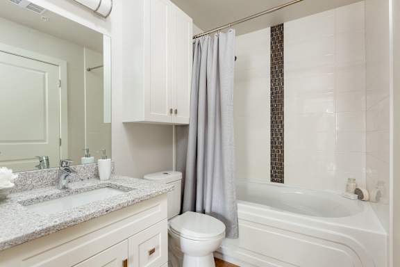 a bathroom with a sink toilet and a bath tub