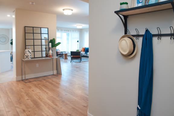 a view of a living room and a hallway with wood floors and a blue curtain