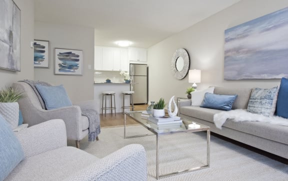 a living room with couches and chairs and a table