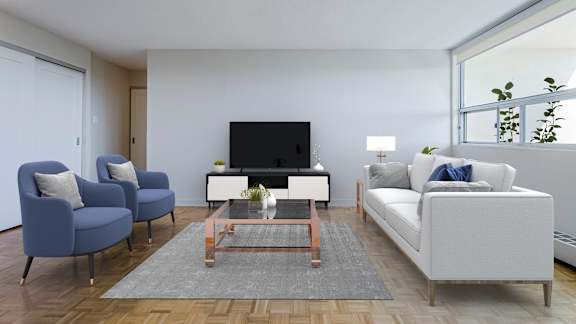 a living room with white couches and chairs and a television