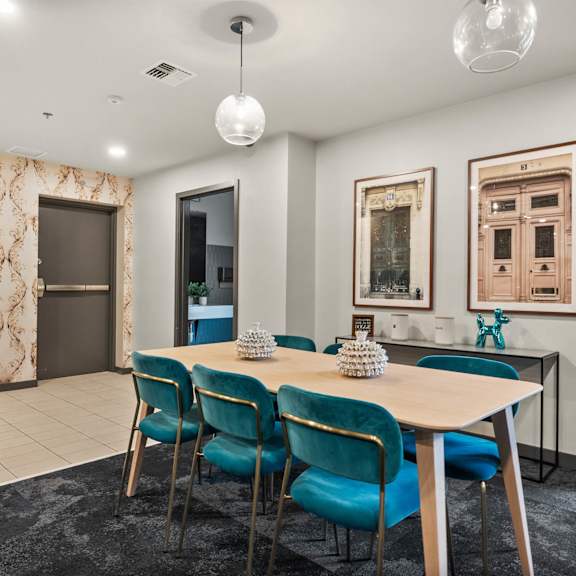 A dining room with a table set for four.