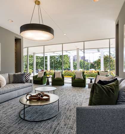 a large living room with couches and chairs and a table