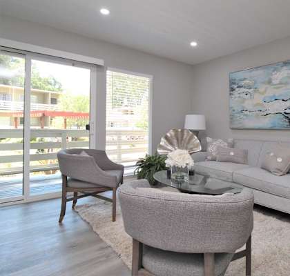 a living room with a couch and chairs