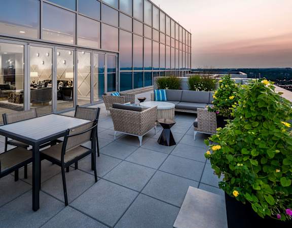 a terrace with tables and chairs on a roof top at 220 Twentieth Street, Virginia, 22202