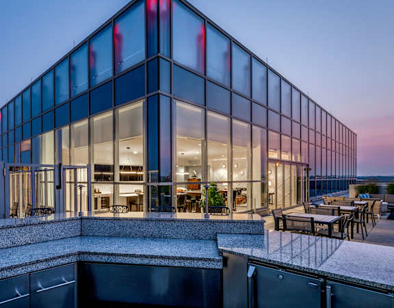 a building with glass windows at dusk at 220 Twentieth Street, Virginia, 22202