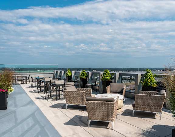 a terrace with tables and chairs overlooking the ocean at 220 Twentieth Street, Virginia, 22202