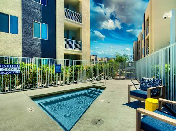 A pool with a sign  at Craft at Gilbert and Baseline Apartments, Apartments, Mesa, AZ
