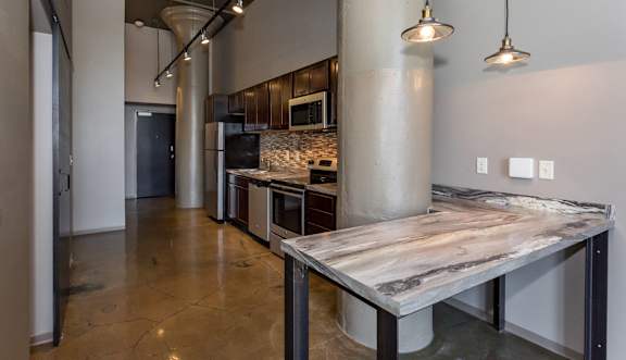 Kitchen with a marble counter top and a stainless steel at Ballyard Lofts, Indigo Living, IA, Iowa , 50309