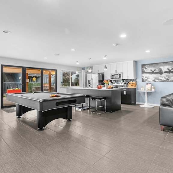 a game room with a pool table and a tv