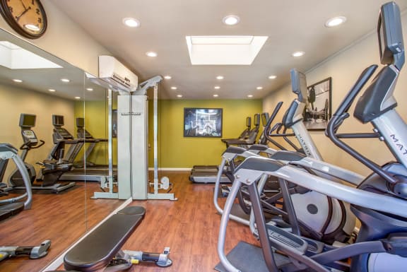 a gym with cardio equipment and a tv on the wall at Valley Plaza Villages, Pleasanton, 94566