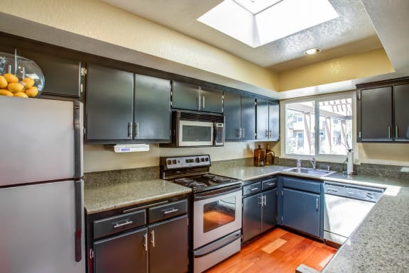 a kitchen with stainless steel appliances and granite counter tops at Valley Plaza Villages, Pleasanton, 94566