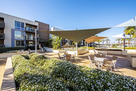 a patio with tables and chairs and umbrellas at Marina Harbor, Marina del Rey, California