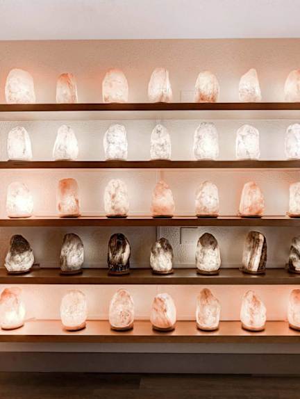 A wall of shelves with glowing skulls on them.