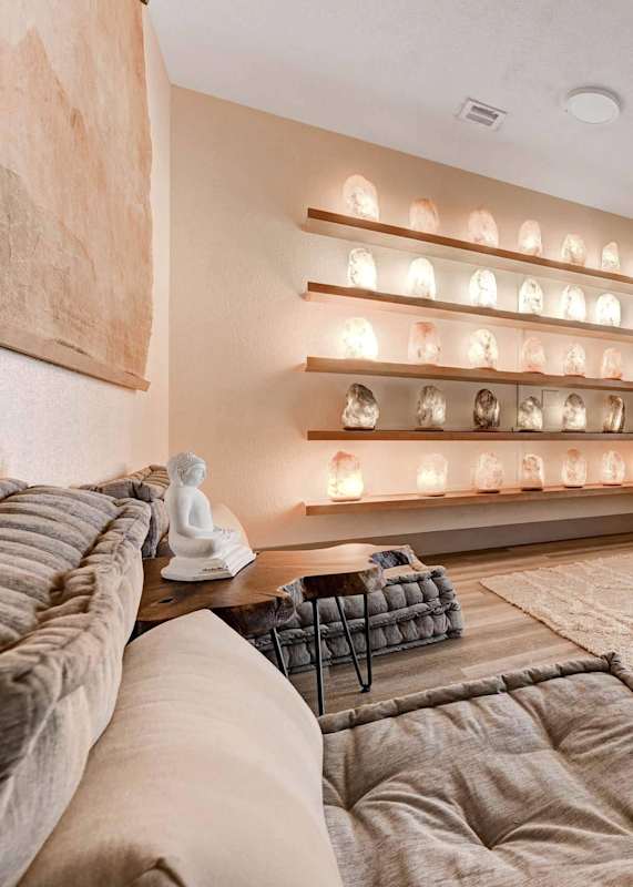 A wall of shelves with glowing skulls on them.