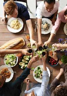 a group of people sitting around a table eating food