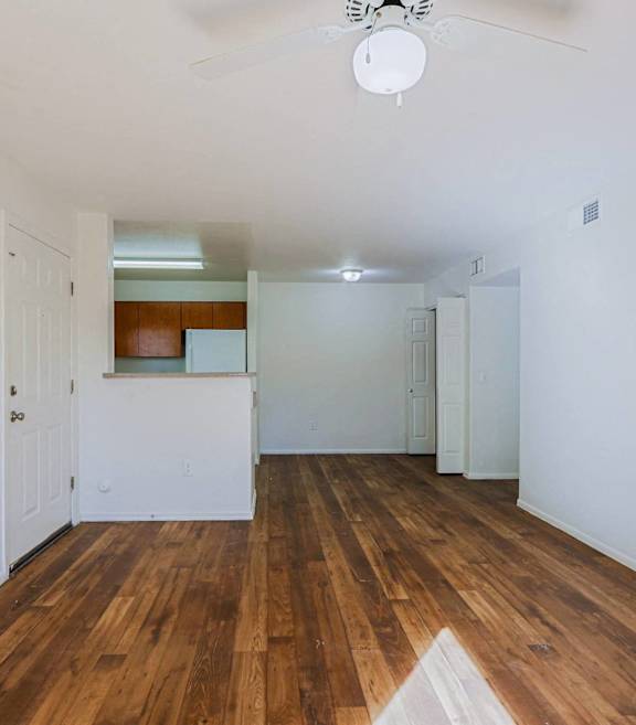 A room with wooden floors and white walls.