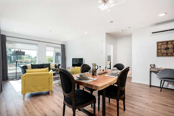 a dining room with a wooden table and chairs