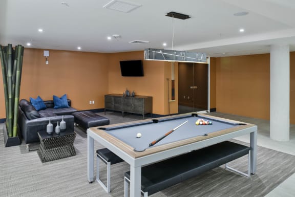 a games room with a pool table and couches at Esprit Apartments, Marina del Rey, CA