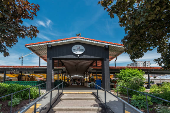 the entrance to a train station with stairs and a blue sky