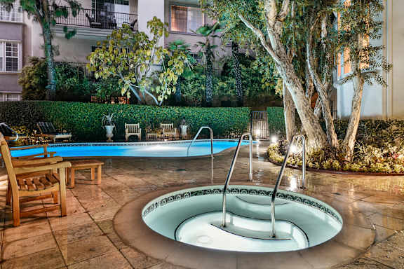 a small pool with a fountain in the middle