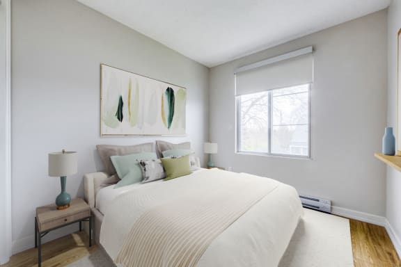 a bedroom with a large bed and a window