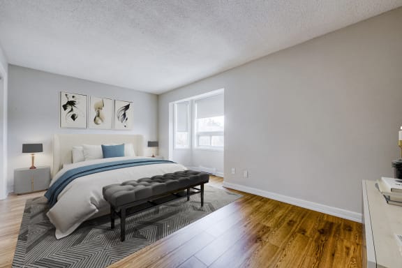 an empty bedroom with a bed and a window