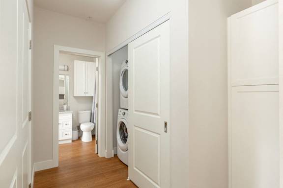 a bathroom with a washer and dryer in a door