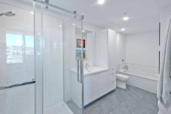 A white bathroom with a walk-in shower.