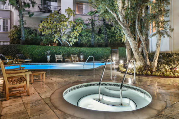 a small pool with a fountain in the middle