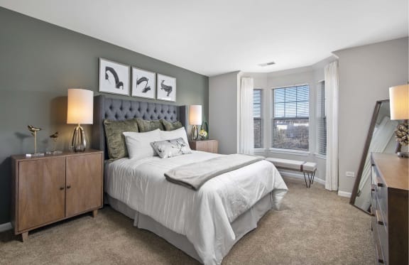 a bedroom with a large bed and a window