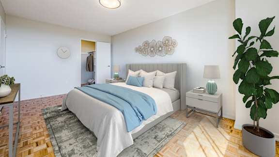 a bedroom with a large bed and a rug