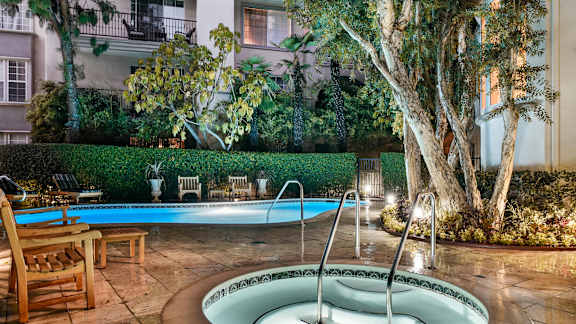 a small pool with a fountain in the middle