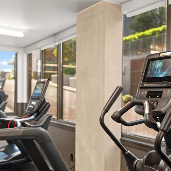 A gym with a variety of equipment including a leg press machine.