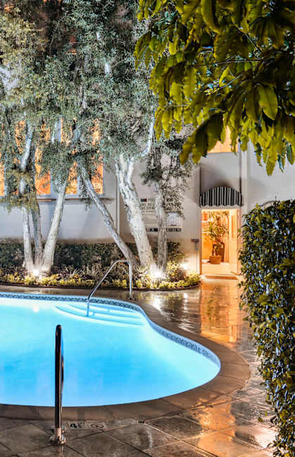 a swimming pool in the backyard of a house with trees at L'Estancia, Studio City, CA, 91604