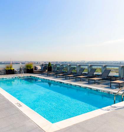 the pool on the rooftop of a building with chairs around it at 220 Twentieth Street, Virginia, 22202