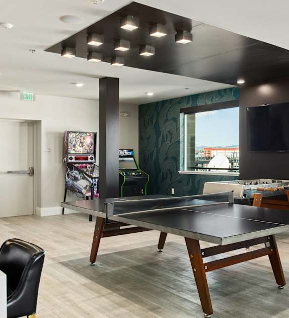 A modern interior with a staircase and glass doors leading to a balcony.