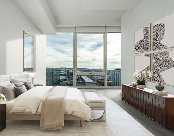 a bedroom with a bed and a view of the city