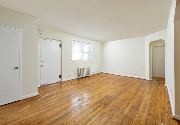 A room with wooden floors and white walls.