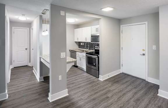 a renovated kitchen with white cabinets and black appliances at COVE West Hartford, Connecticut, 06119