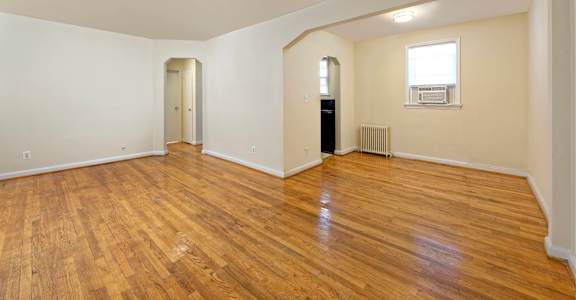 A room with wooden floors and white walls.