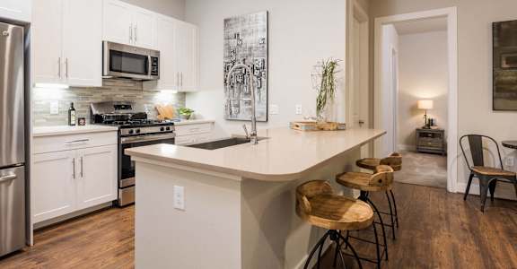 a kitchen with an island and stools
