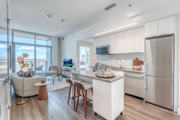a kitchen with a island and a living room at BLVD Beltline, Calgary, Alberta, T2G 2K4