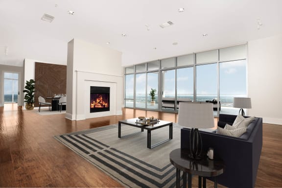the living room has a fireplace and a view of the ocean at The Heights at Park Lane, Texas, 75231