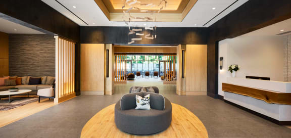 a cat sits in a chair in the lobby of a hotel