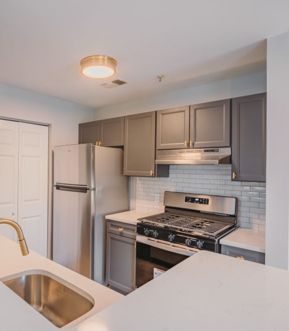 a kitchen with stainless steel appliances and a white counter top at Ardenwood Apartments, Connecticut