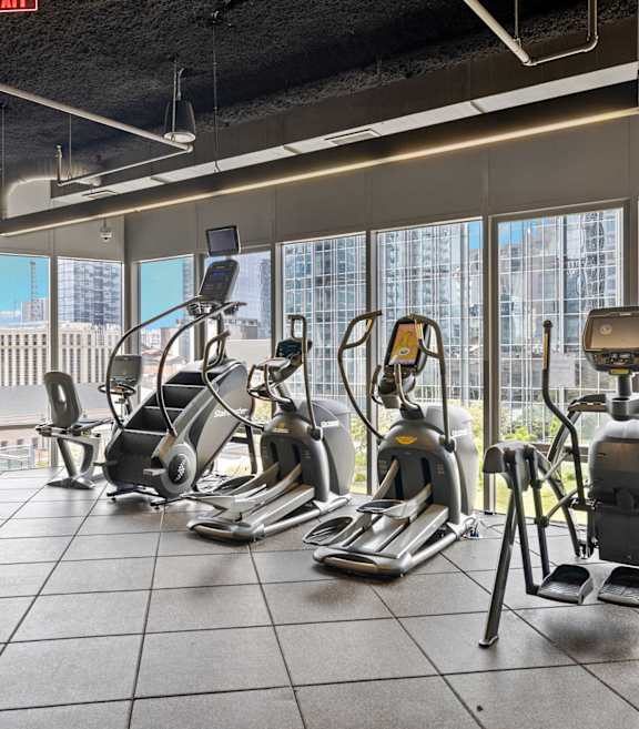 A gym with treadmills, exercise bikes, and elliptical machines.