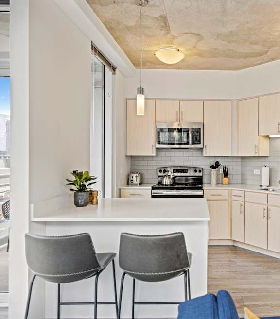 A kitchen with a refrigerator, stove, and oven.