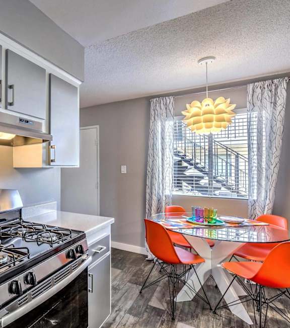 A modern kitchen with a stainless steel refrigerator and a stove top oven.