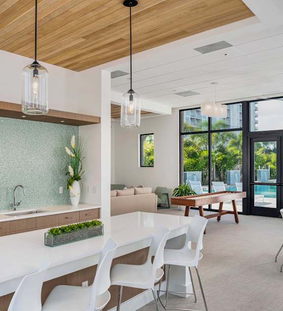 A modern kitchen with a white table and chairs.